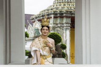 Thai traditionally and festively dressed young woman, Wat Pho, Bangkok, Thailand, Asia