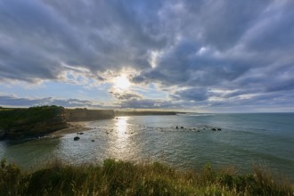 Sunrise over calm sea, dramatic clouds and light reflections, Opunake, Taranaki, North Island, New