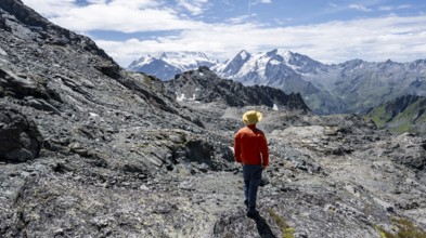 Mountaineer in rocky mountain landscape at the Col du Louvie, view of the summit of the Grand