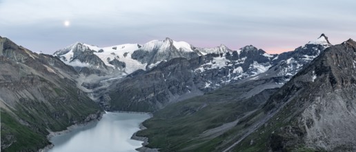 Mountain landscape with turquoise blue reservoir Lac des Dix and summit Mont Blanc de Cheilon, moon