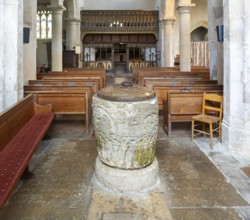 Historic baptismal font inside village parish church of Saint James, Avebury, Wiltshire, England,