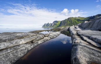 Reflection in a tidal pool, rocky coast of Tungeneset, Devil's Teeth, Okshornan, Ersfjorden, Senja