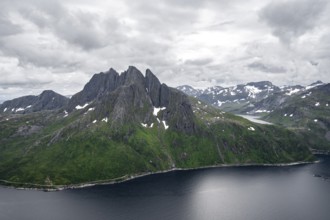 View of Mefjorden fjord from Barden mountain, Breidtind mountain peak behind, Senja, Norway, Europe