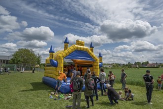 Children's fun, bouncy castle and football games in a meadow during the baking oven festival,