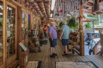 Senior men on the front porch of Bearmeats Indian Den arts, crafts and souvenir shop in Cherokee,
