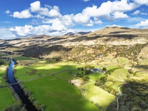 Farms and Mountains over River Dochart and Road A85 from a drone, Perthshire, Scotland, UK