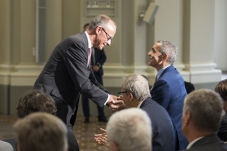 Friedrich Merz (Chancellor of the Federal Republic of Germany) congratulates Ugur Sahin (founder of