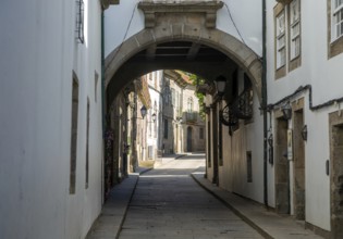 Narrow medieval street Rua de Santa Maria, city centre of Guimaraes, northern Portugal