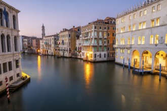 View of the Grand Canal at sunset, picturesque evening mood with illuminated palazzos on the canal
