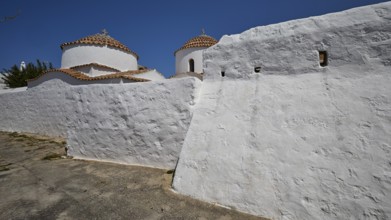 Church of Agia Kioura, White, rustic monastery building with domes under a clear sky, Church,