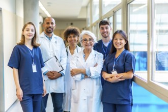 Doctors and nurses standing together in a hospital corridor, representing teamwork and
