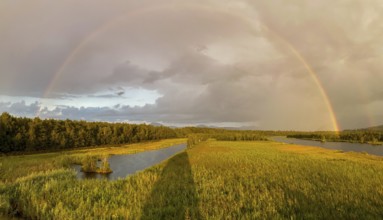 Complete and partial double rainbow in the Ainringer and Peracher moss nature reserve, Bavaria,