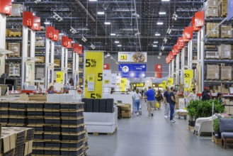Customers shopping in the warehouse section of IKEA home store