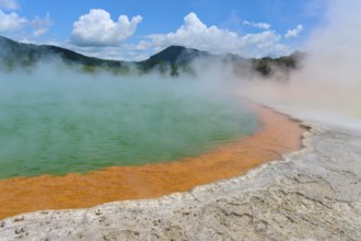 Bubbling mineral spring with steam and surrounded by mountains, Champagne Pool thermal lake,