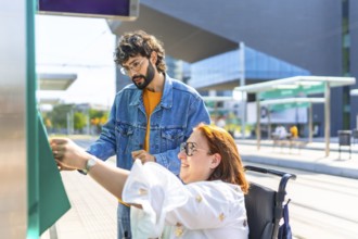 Woman in a wheelchair validating her ticket at a modern tram stop, with a friend providing