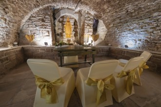 Ritual room in the historic cellar with chairs and decoration for a ceremony, family celebration in