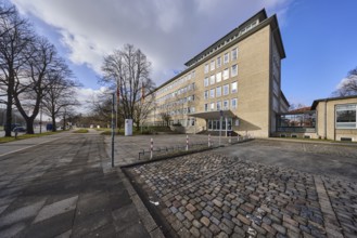 Tax office Hannover-Mitte, office building, pavement, paving slabs, bare wintry trees, blue sky,