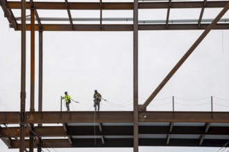 Detroit, Michigan - Workers string safety lines as structural steel rises on a $2.2 billion