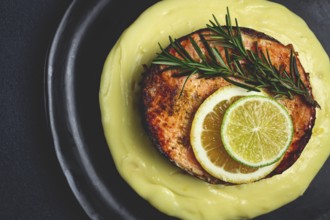Salmon steak, fried, mashed potatoes, top view, rosemary, lemon and lime, homemade, one serving, no