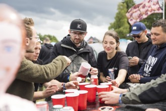 Festival visitors play a drinking game on a campsite at the Rock am Ring Festival on Saturday,