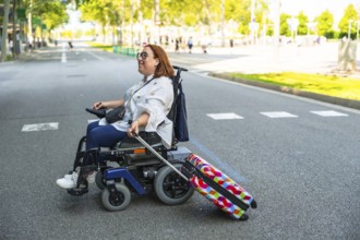 Happy woman with disability enjoys her accessible travel, pulling colorful suitcase while riding