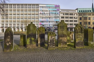 Historic gravestones, general architecture, diffuse light, pale blue cloudy sky, slightly sunny,