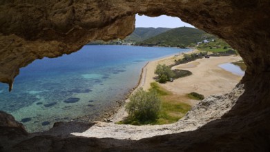 View from a rock cave onto a beach and the turquoise sea, Petra beach, cave, Grikos, rocks of