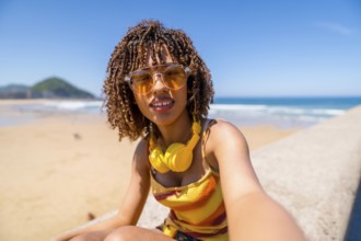 Tourist enjoying summer holidays at the beach, capturing a joyful selfie while soaking up the sun,