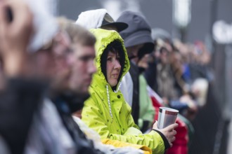 A festival visitor wearing a rain jacket stands in the front row at the Rock am Ring Festival on