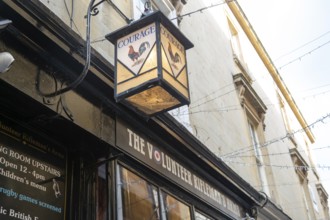 Vintage Courage pub lamp sign outside The Volunteer Rifleman's Arms pub, city of Bath, north east