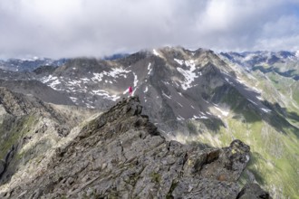 Hiker on a rock, Lasörling Höhenweg, Lasörling Group, Hohe Tauern National Park, East Tyrol, Tyrol,