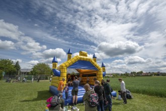 Children's fun, bouncy castle and football games in a meadow during the baking oven festival,