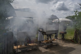 Heavy smoke at the sausage grill stations at the Backofenfest, Kleingeschaidt, Middle Franconia,