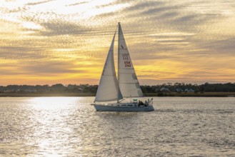 Sailboat sailing on the Tolomato River near Vilano Beach, Florida at sunset