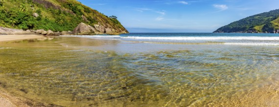 Clear waters at Bonete beach in Ilhabela surrounded by hills and forest, Ilhabela, Sao Paulo,