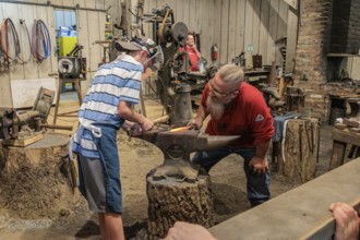 Park guest gets hands on experience at the Valley Forge Blacksmith demonstration at the Dollywood