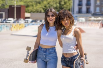Two young women smiling and holding skateboards, enjoying their time together in a vibrant