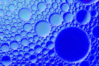 Colorful abstract macro background with oil drops in water
