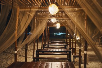 Empty beach restaurant lounge bar with lantern in the evening on tropical island. Summer vacation,