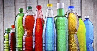 Plastic bottles of assorted carbonated soft drinks in variety of colors