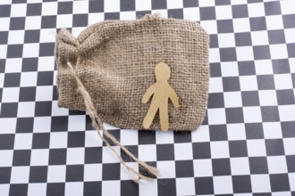 Man shape cut out of paper on canvas sack