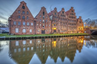 The historic salt warehouse with the river Trave at dawn, seen in Lübeck, Germany, Europe