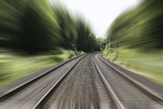 double-track railroad railway or train tracks with speed motion blur - fast travel concept
