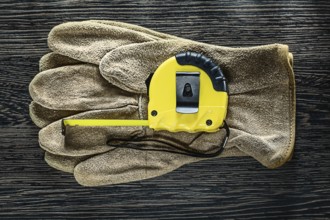 Tapeline leather protective gloves on wooden board