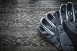A pair of protective gloves on a wooden board