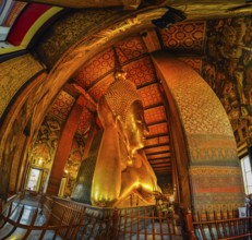 Photo of large lying golden Buddha statue in temple Wat Pho in capital city in Bangkok, Thailand,