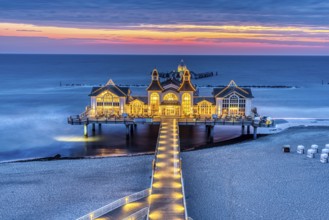 Pier with restaurant seen in front of sunrise on the island of Rügen, Germany, Europe