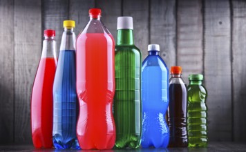 Plastic bottles of assorted carbonated soft drinks in variety of colors