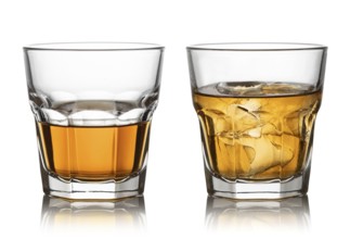 Glass of whisky and ice isolated white background