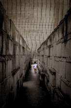 Caucasian young kid walking with labyrinth perspective. Conceptual image for dangerous situation